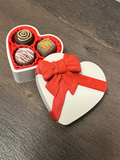 Chocolate clickers in a heart shaped box
